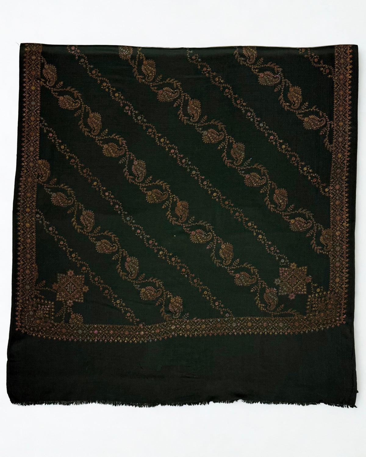 Forest green Swati Shahtoosh shawl laid flat, full diagonal paisley jaal in copper, gold and rose with two embroidered corner medallions and border
