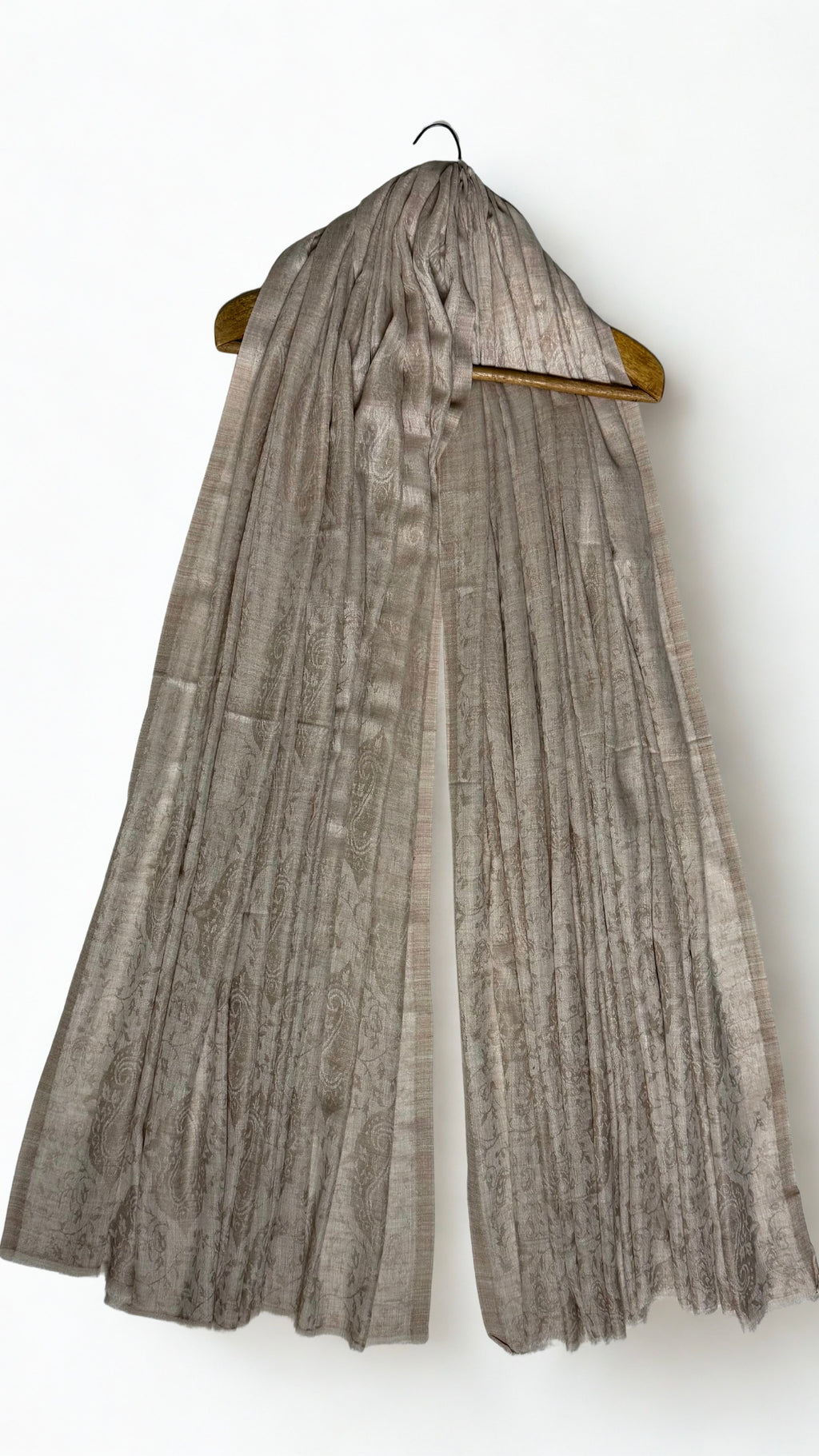 Stone taupe Palladar shawl draped on a hanger, the silvery sheen of the fine pashmina catching the light