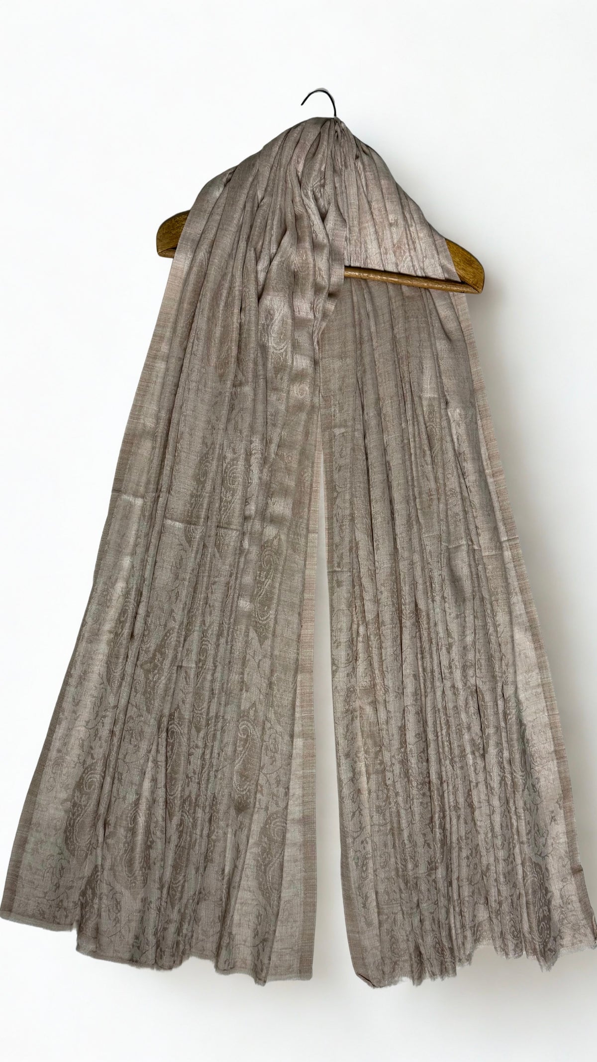 Stone taupe Palladar shawl draped on a hanger, the silvery sheen of the fine pashmina catching the light