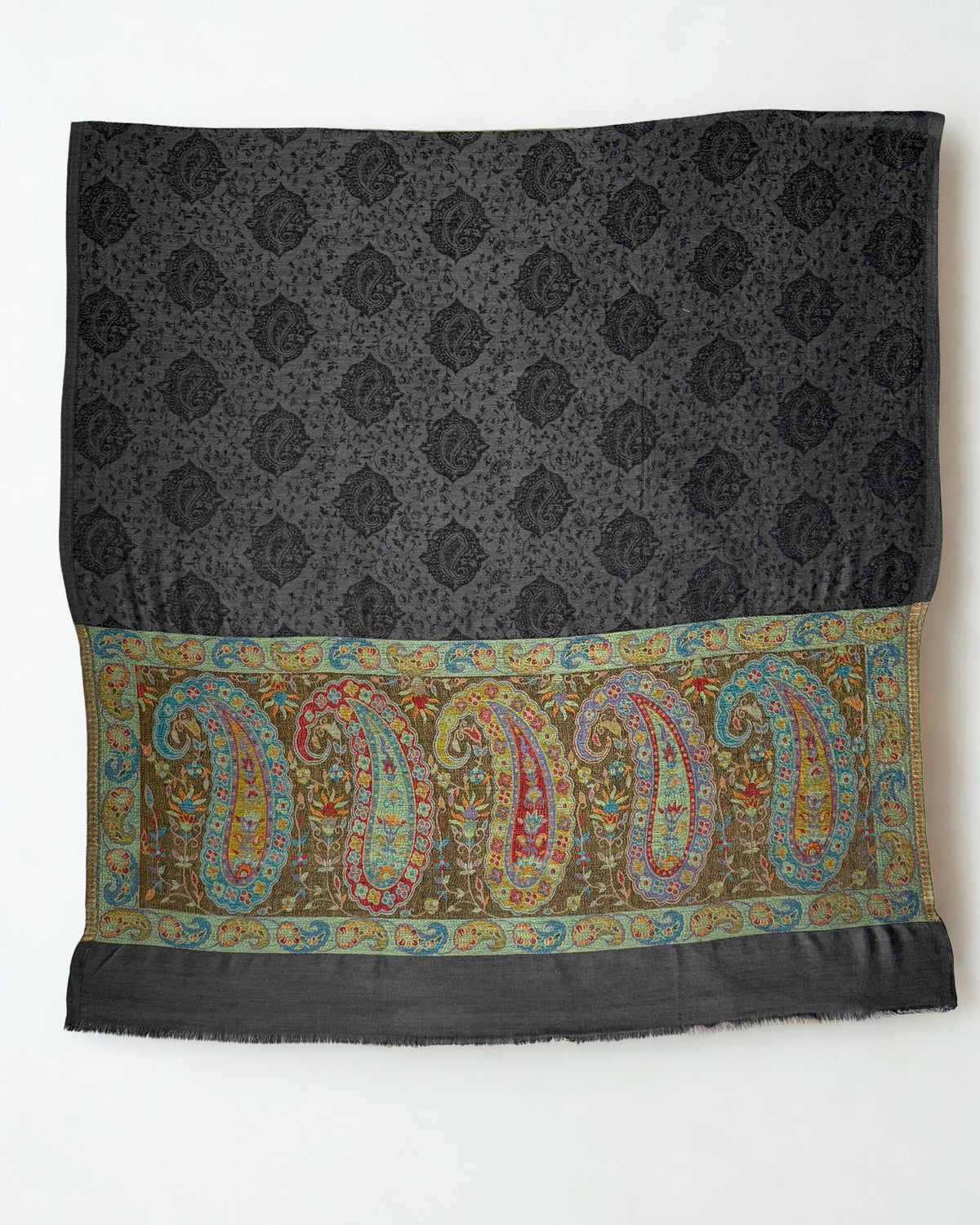 Dark charcoal pashmina ring shawl laid flat, showing the woven black paisley field and five large multicolour paisleys across the palla
