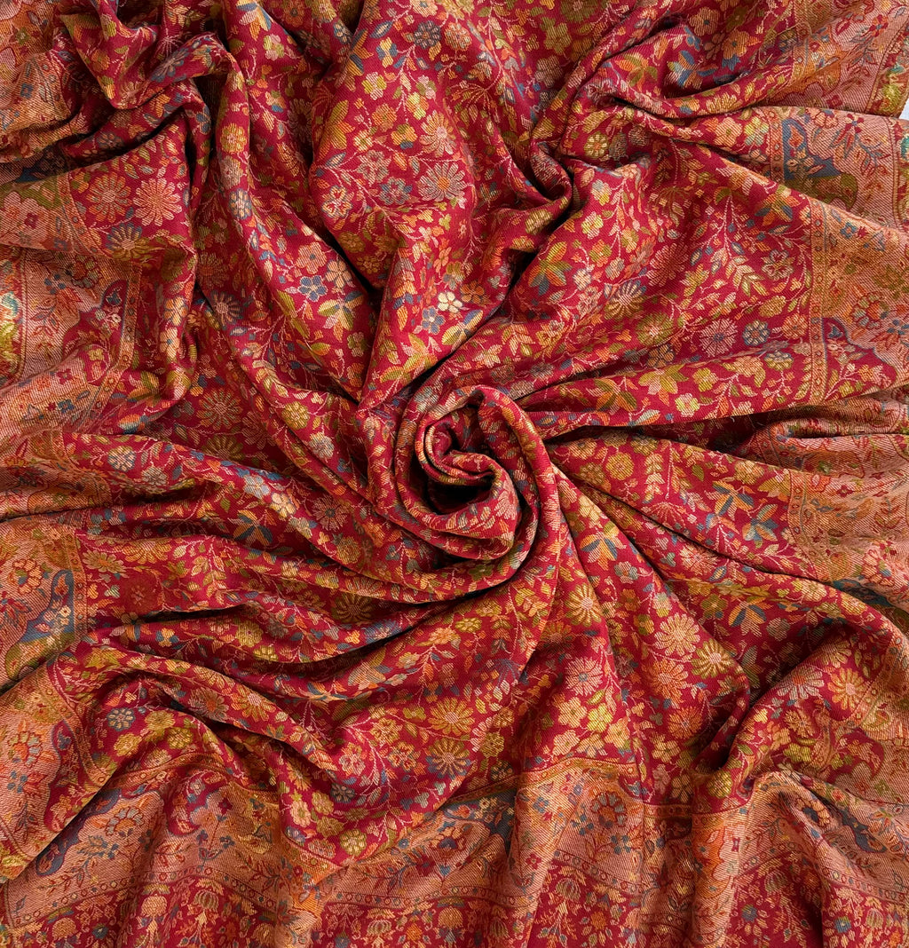 Crimson Zari Kani pashmina shawl arranged in folds, showing the border on all four sides and the fringed edge