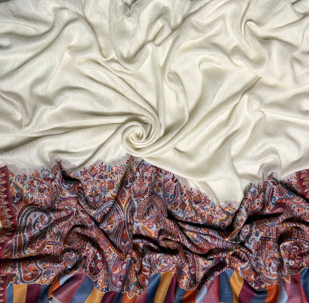 White ek rukh pashmina shawl drawn through a finger ring, showing the fineness of the hand-spun cloth
