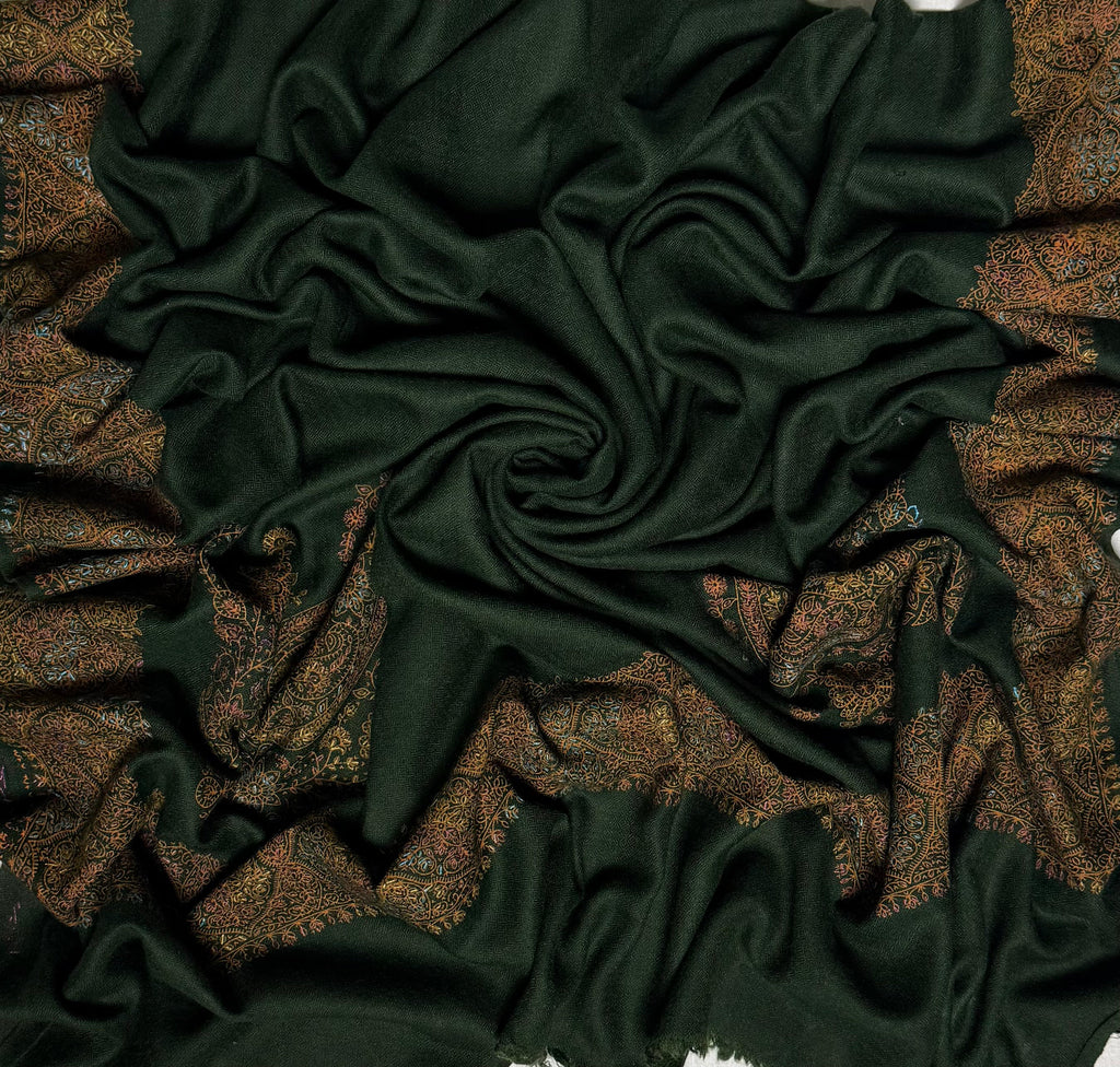 Close view of the hand-embroidered medallion border on the forest green Swati Shahtoosh shawl, worked in gold, copper, rose and pale blue thread