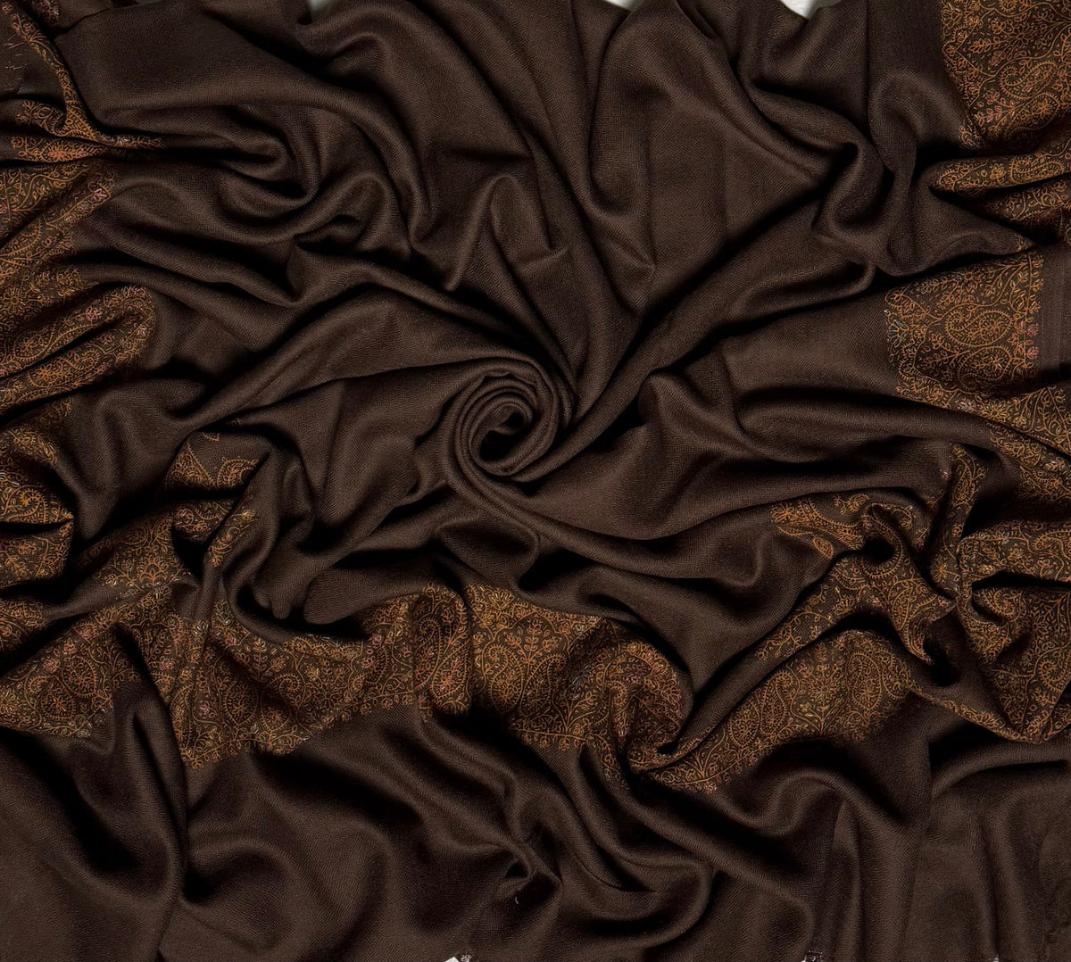 Close view of the espresso brown Swati Shahtoosh shawl, showing the hand-embroidered paisley border and the self-coloured lattice of the ground