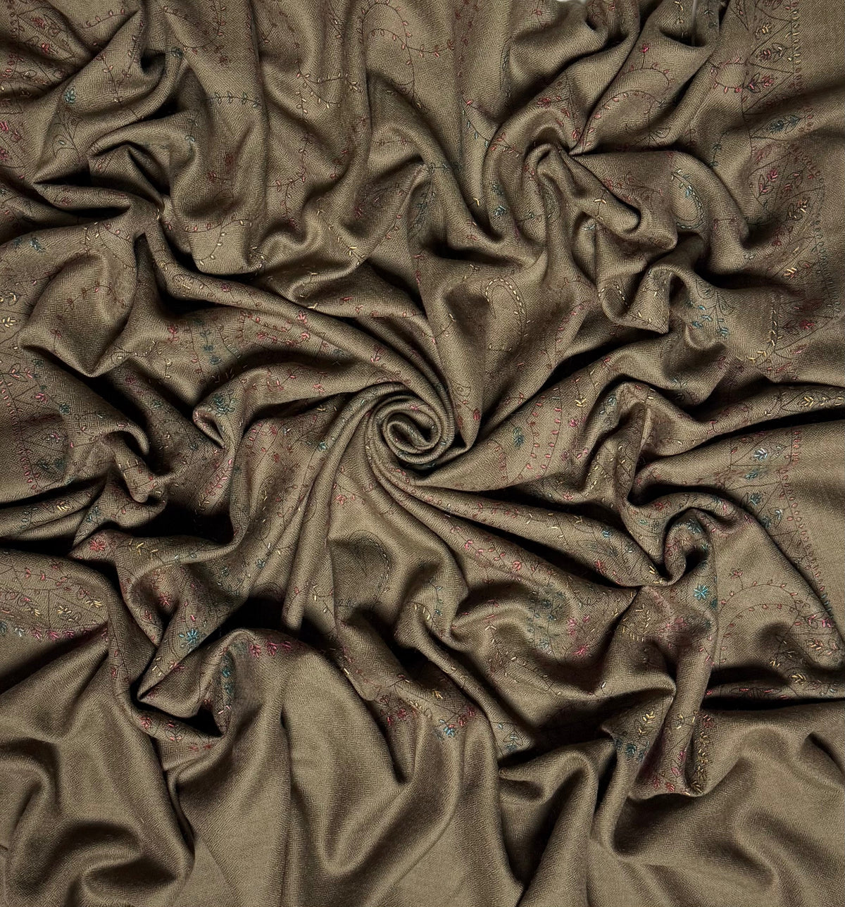Close view of the olive brown Swati Shahtoosh shawl, showing the hand-embroidered paisley jaal and the self-coloured herringbone weave of the ground