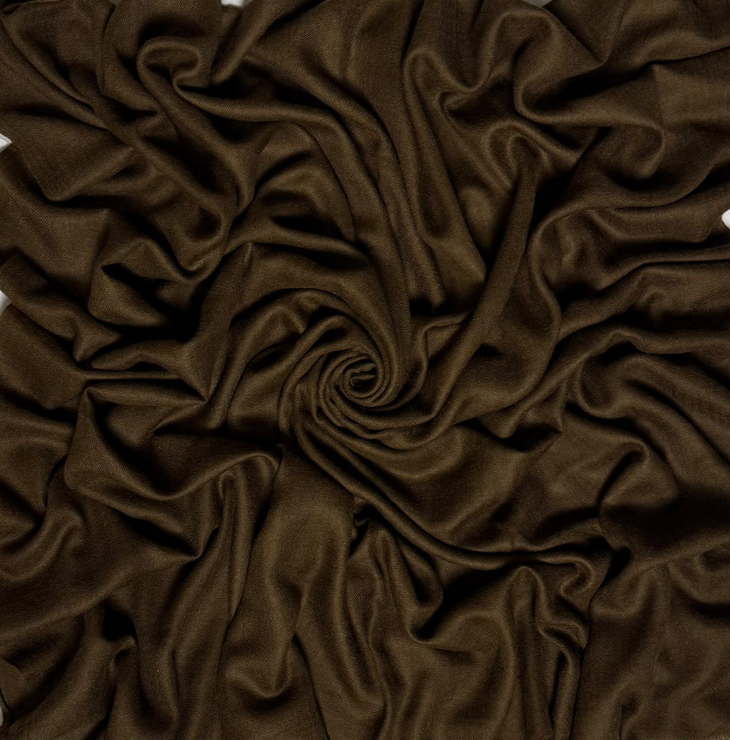 Close view of the warm brown Swati Shahtoosh shawl, showing the self-coloured diamond weave and fringed end
