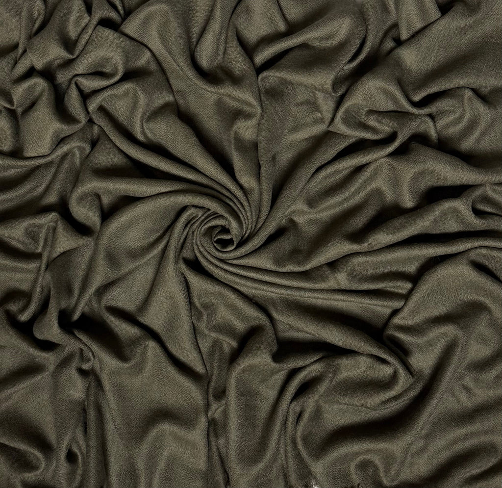 Close view of the olive Swati Shahtoosh shawl, showing the self-coloured diamond weave and fringed end