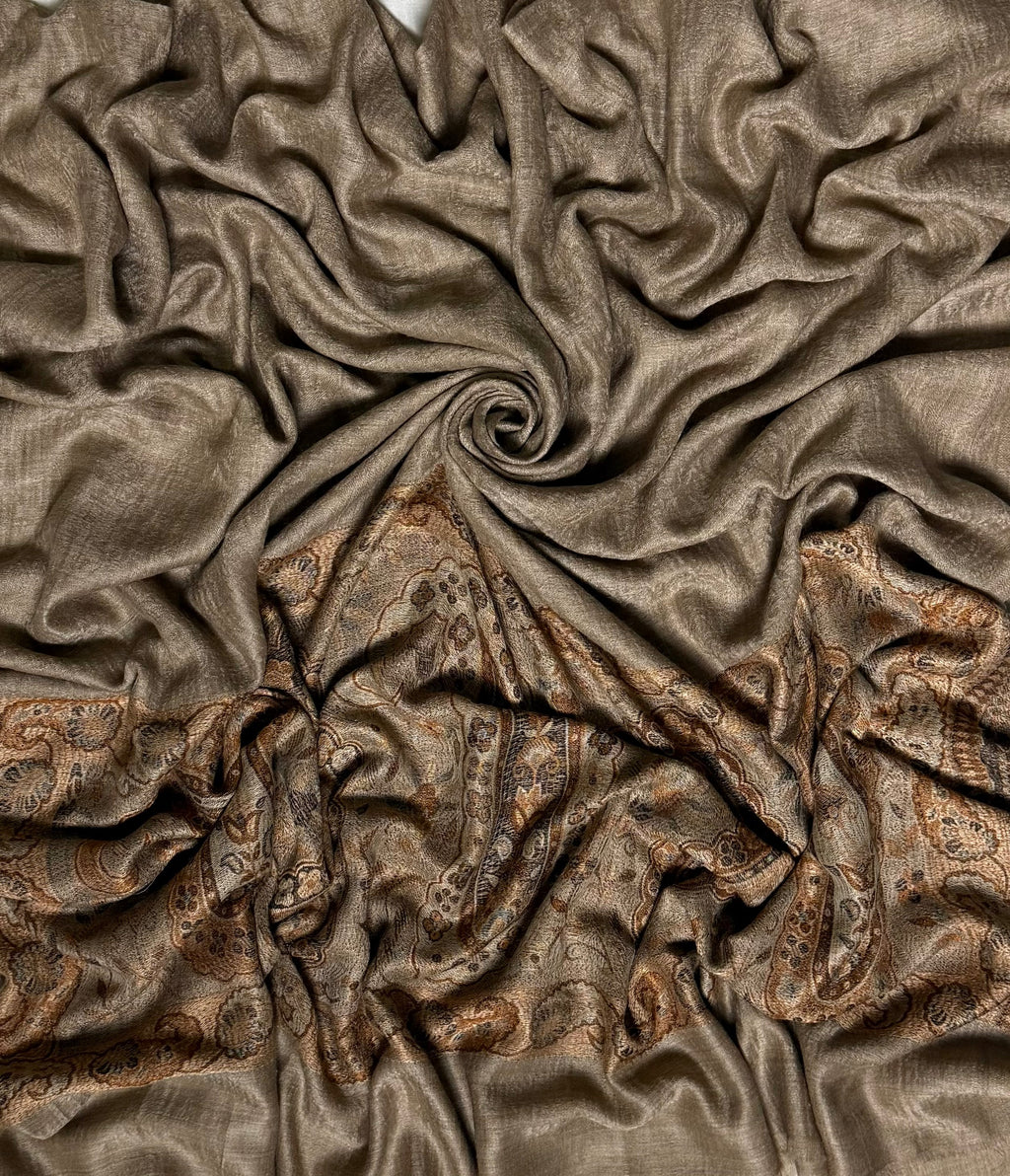 Warm khaki Palladar shawl swirled to show the sheen of the fine pashmina and the woven copper paisley end