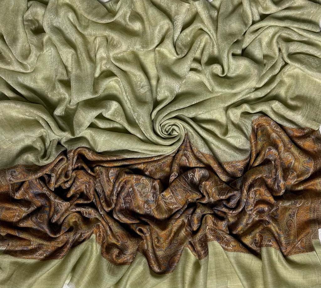 Pistachio Palladar shawl swirled to show the sheen of the fine pashmina and the rich bronze woven end