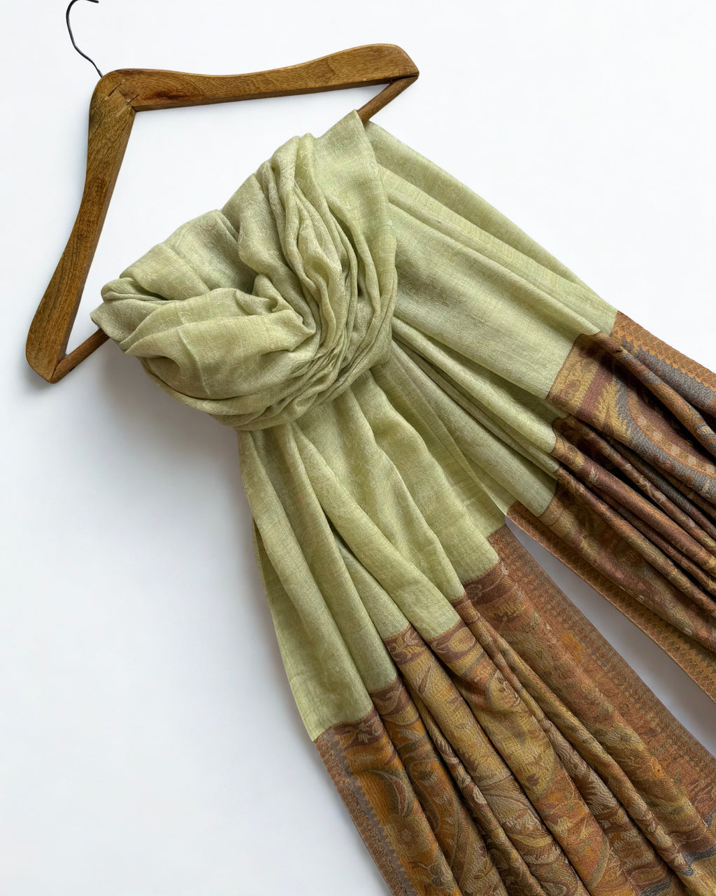 Shawl folded back to show where the pistachio field meets the amber band