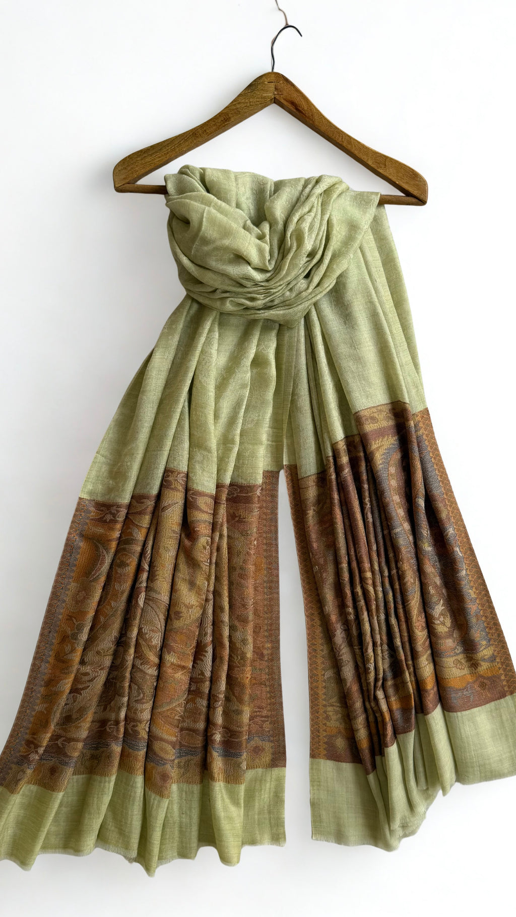 The tonal green-on-green paisley medallions woven across the whole field