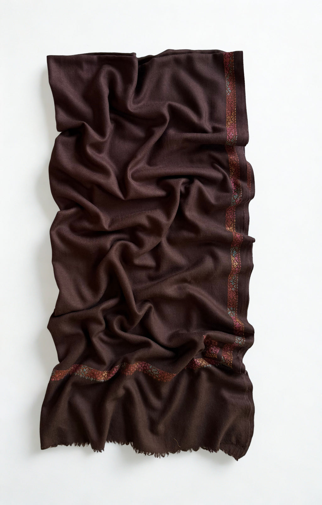 Close view of the rose, coral and teal hand embroidery against the deep espresso brown ground