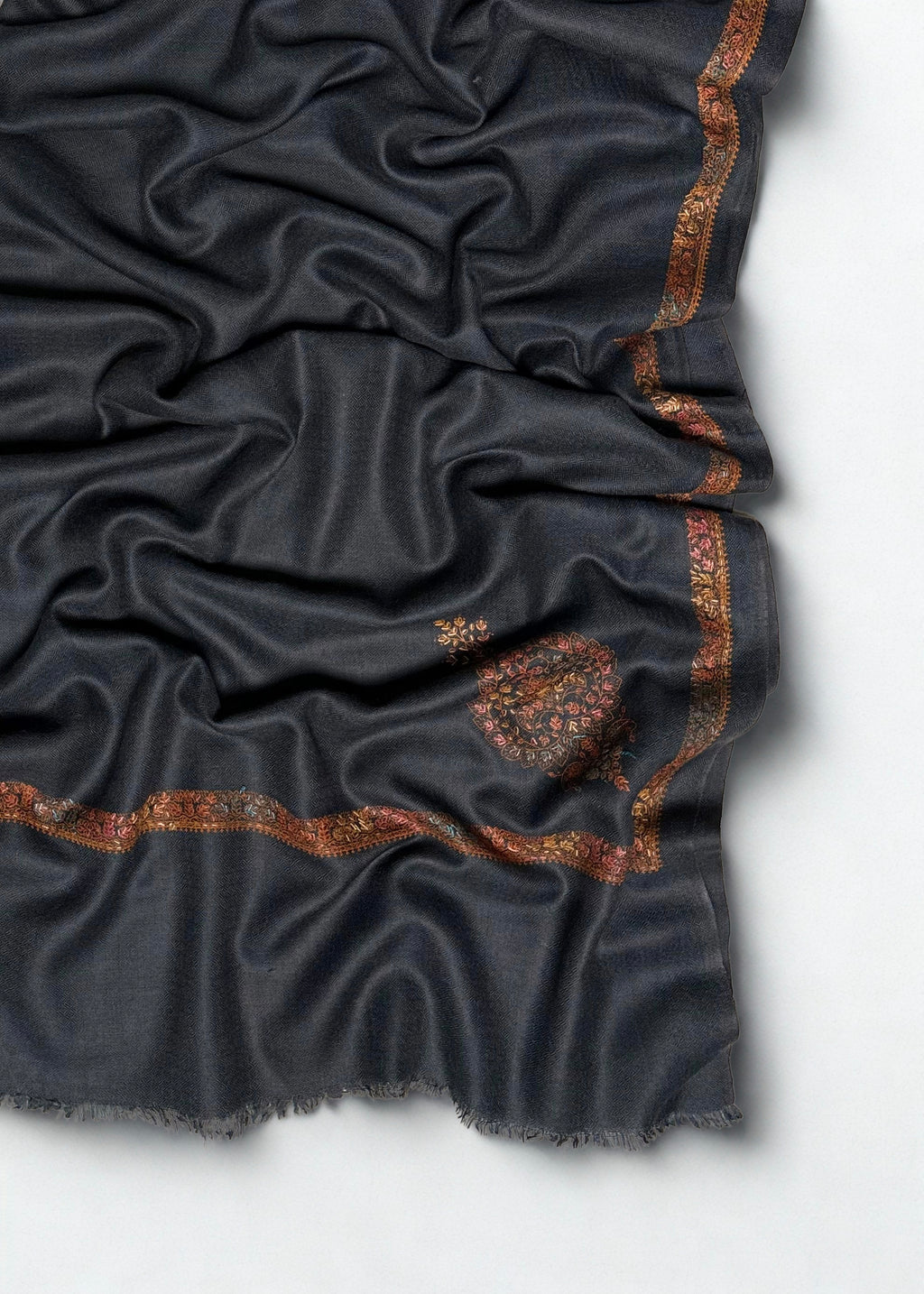 Folded charcoal grey Swati Shahtoosh shawl showing the full length, fine embroidered edge and single paisley buta