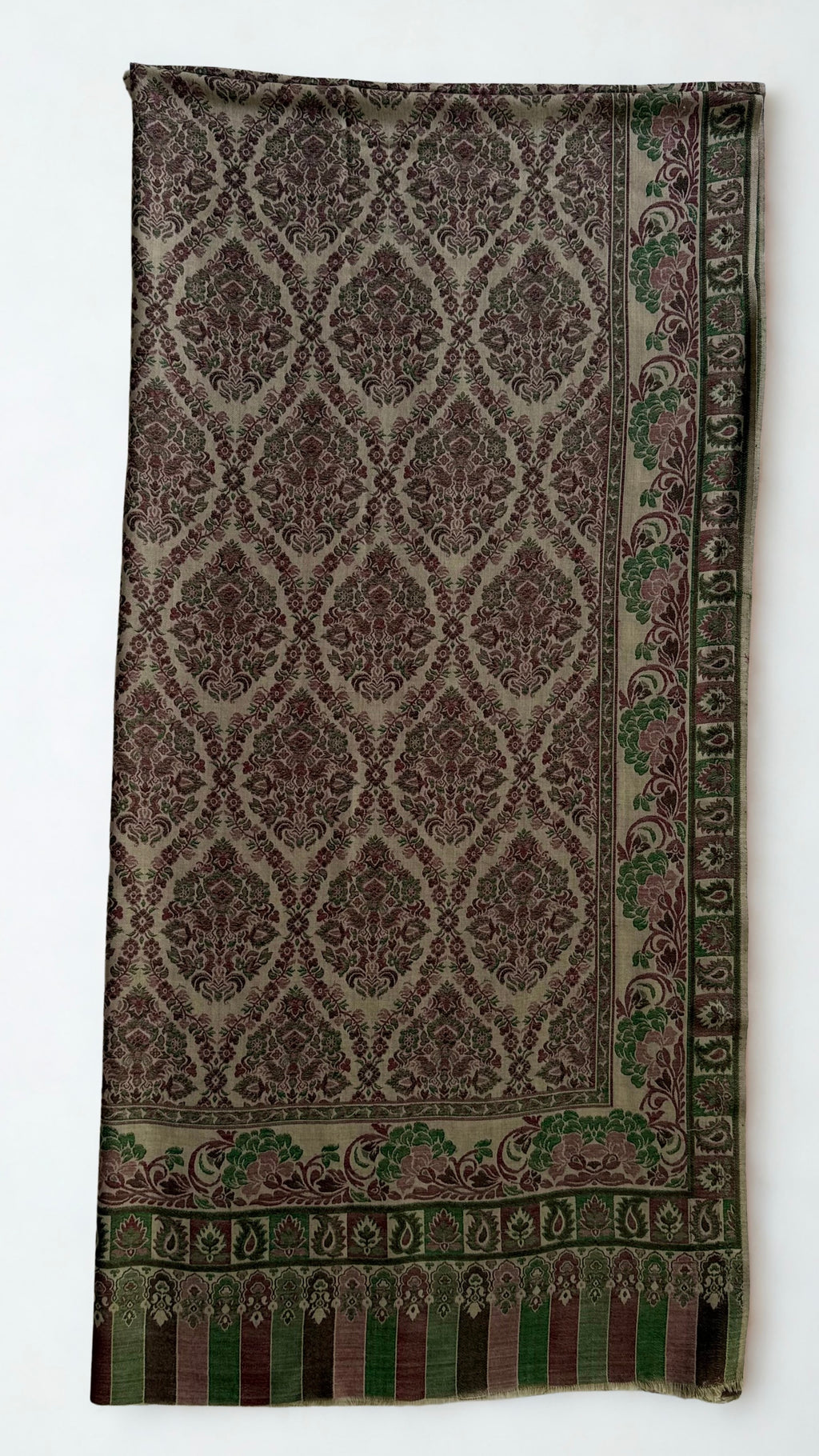 Plum and moss Kani pashmina shawl folded back to show the reverse of the medallion lattice and the striped column end