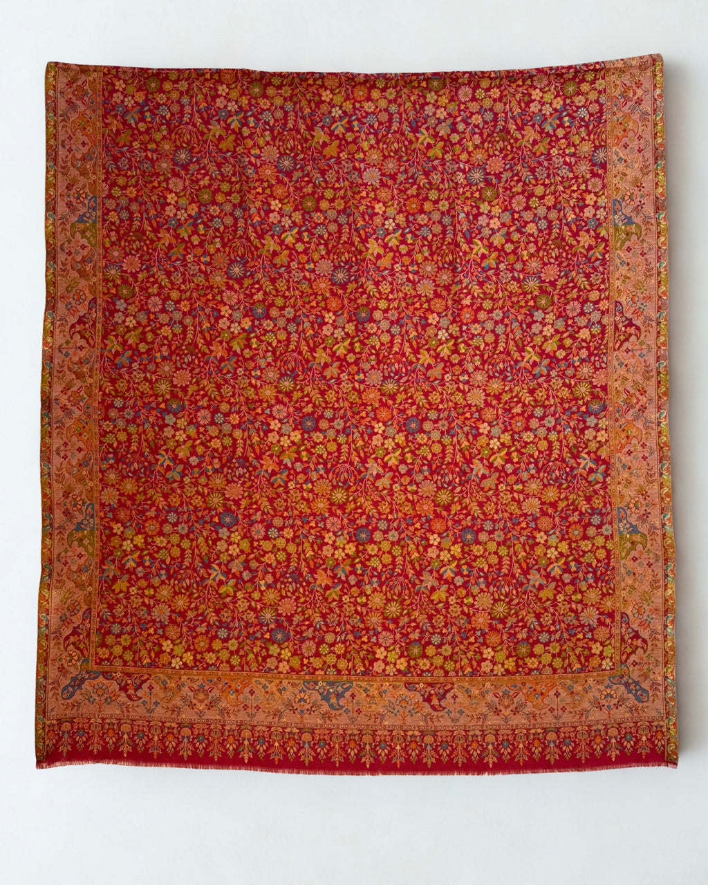 Crimson Zari Kani pashmina shawl folded to show the corner border and the fringed end