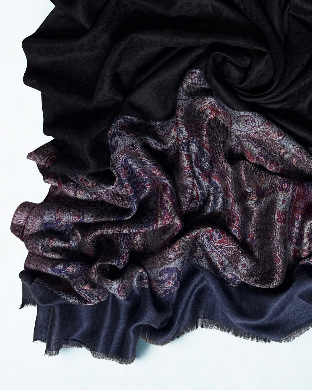 Black pashmina shawl swirled to show its drape against the paisley border