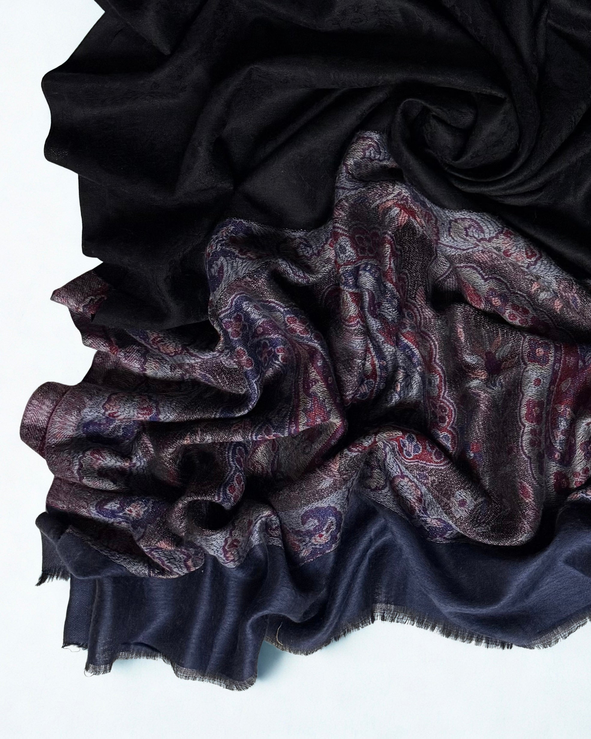Black pashmina shawl swirled to show its drape against the paisley border