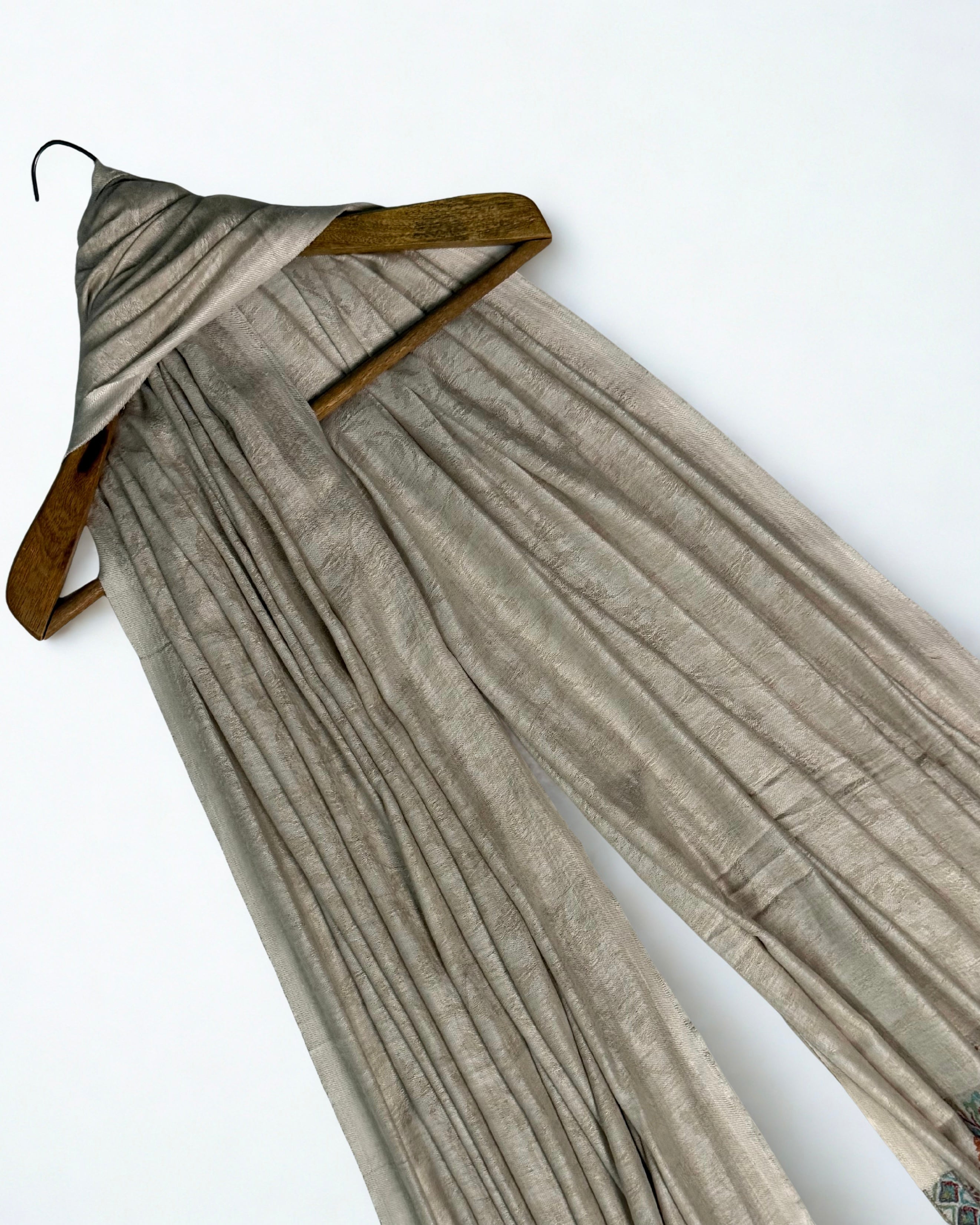 Stone grey Palladar shawl on a wooden hanger, both landscape panels visible
