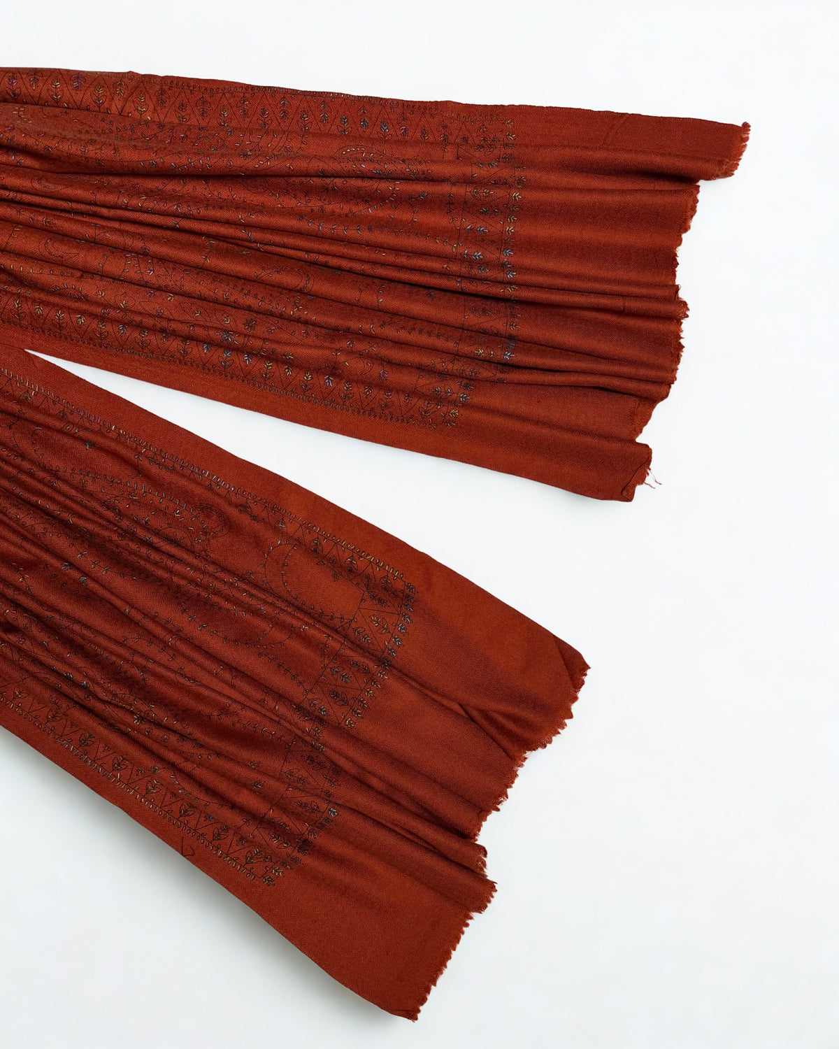 Ends of the rust Swati Shahtoosh shawl showing the hand-embroidered border and fringed edge