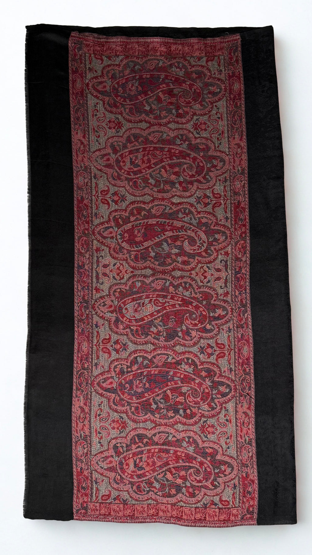 Black Palladar ring shawl folded flat, showing the full crimson paisley end panel against the black self-patterned ground