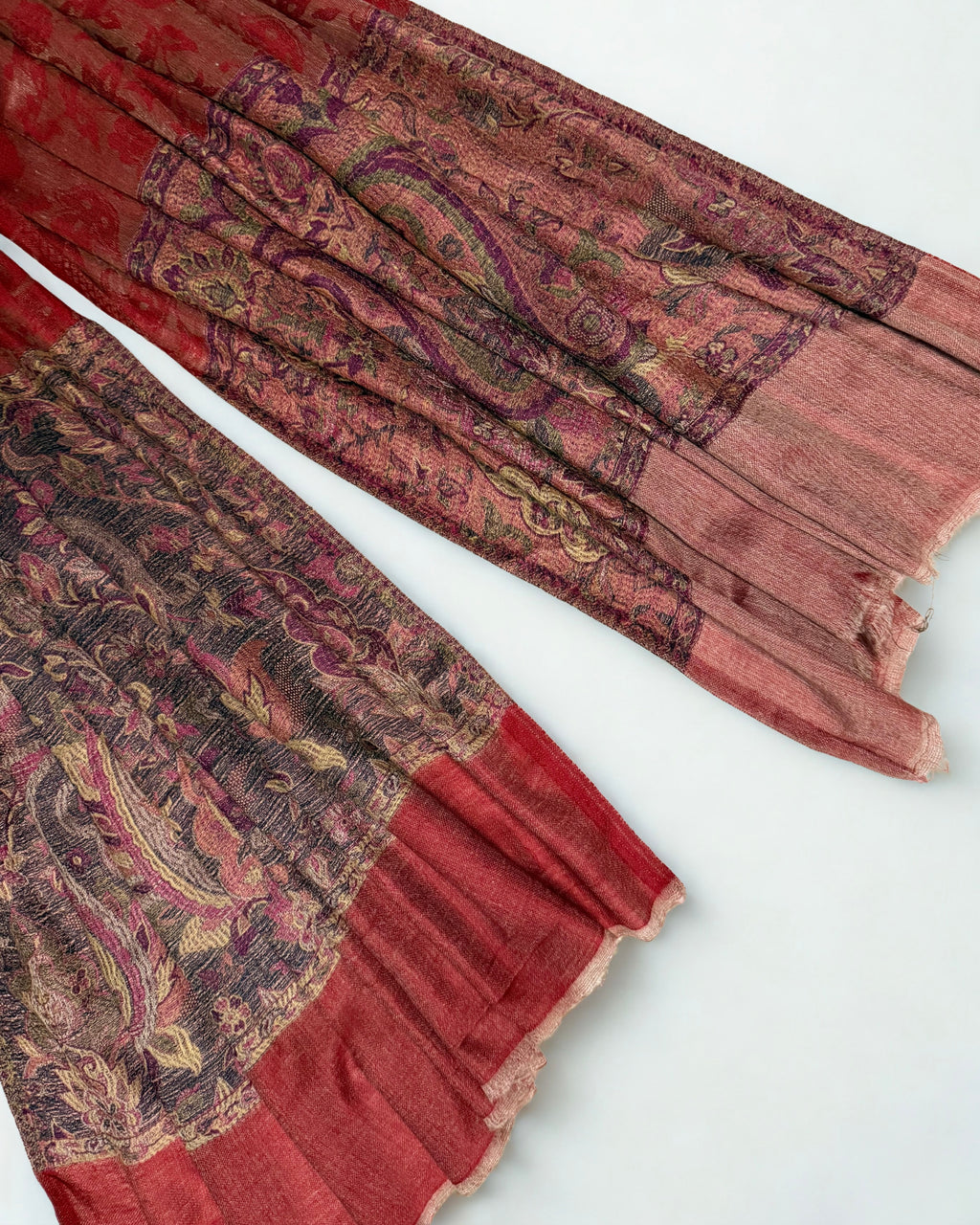 Both end panels of the scarlet pashmina shawl side by side, borders matched