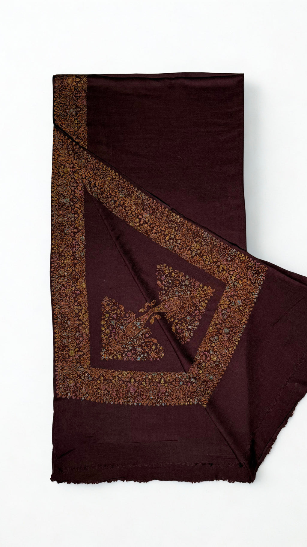 Deep maroon Swati Shahtoosh shawl with one corner turned back, showing the wide hand-embroidered paisley border mitred at the corner around a large flowering paisley
