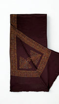 Deep maroon Swati Shahtoosh shawl with one corner turned back, showing the wide hand-embroidered paisley border mitred at the corner around a large flowering paisley
