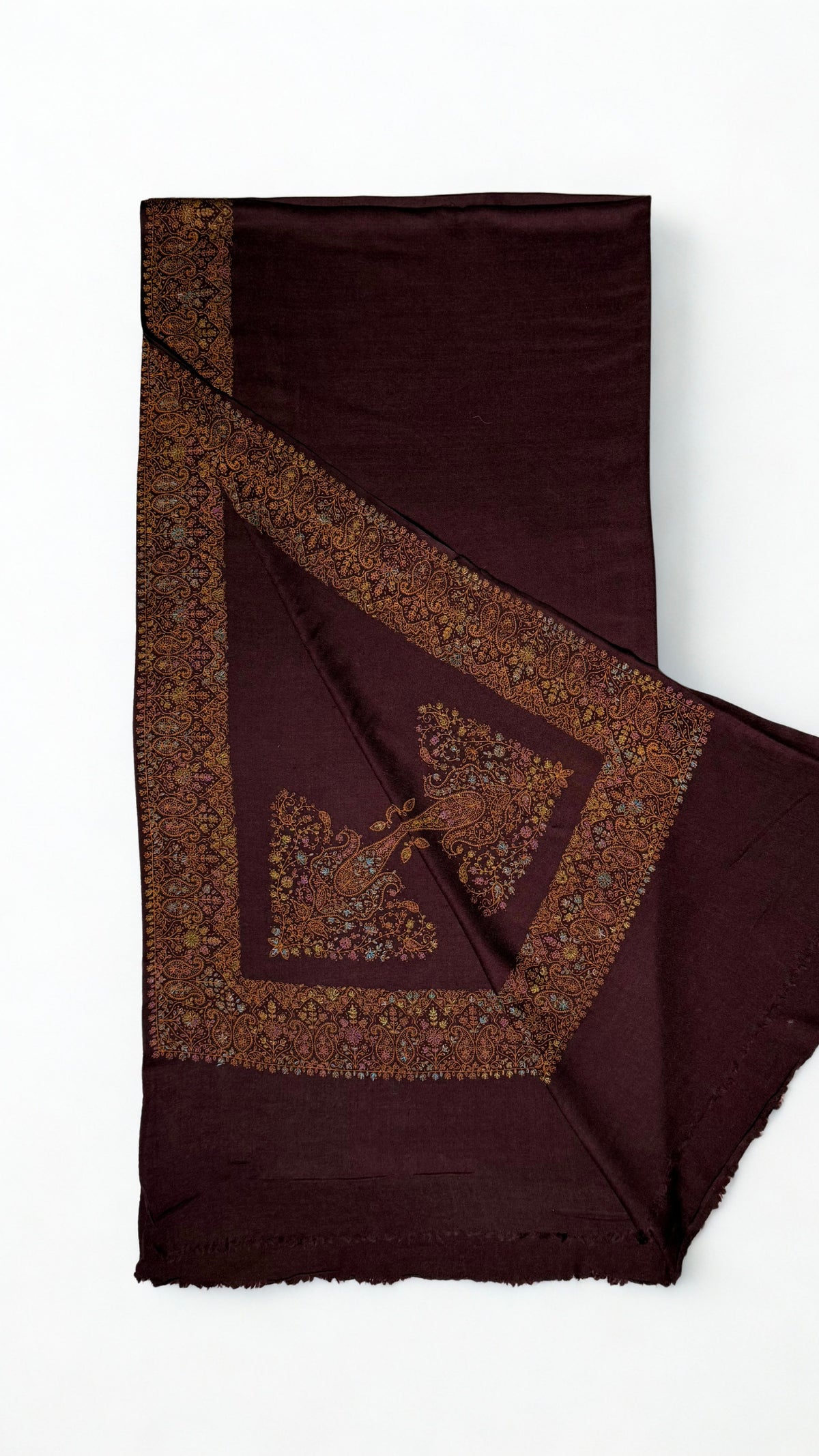 Deep maroon Swati Shahtoosh shawl with one corner turned back, showing the wide hand-embroidered paisley border mitred at the corner around a large flowering paisley