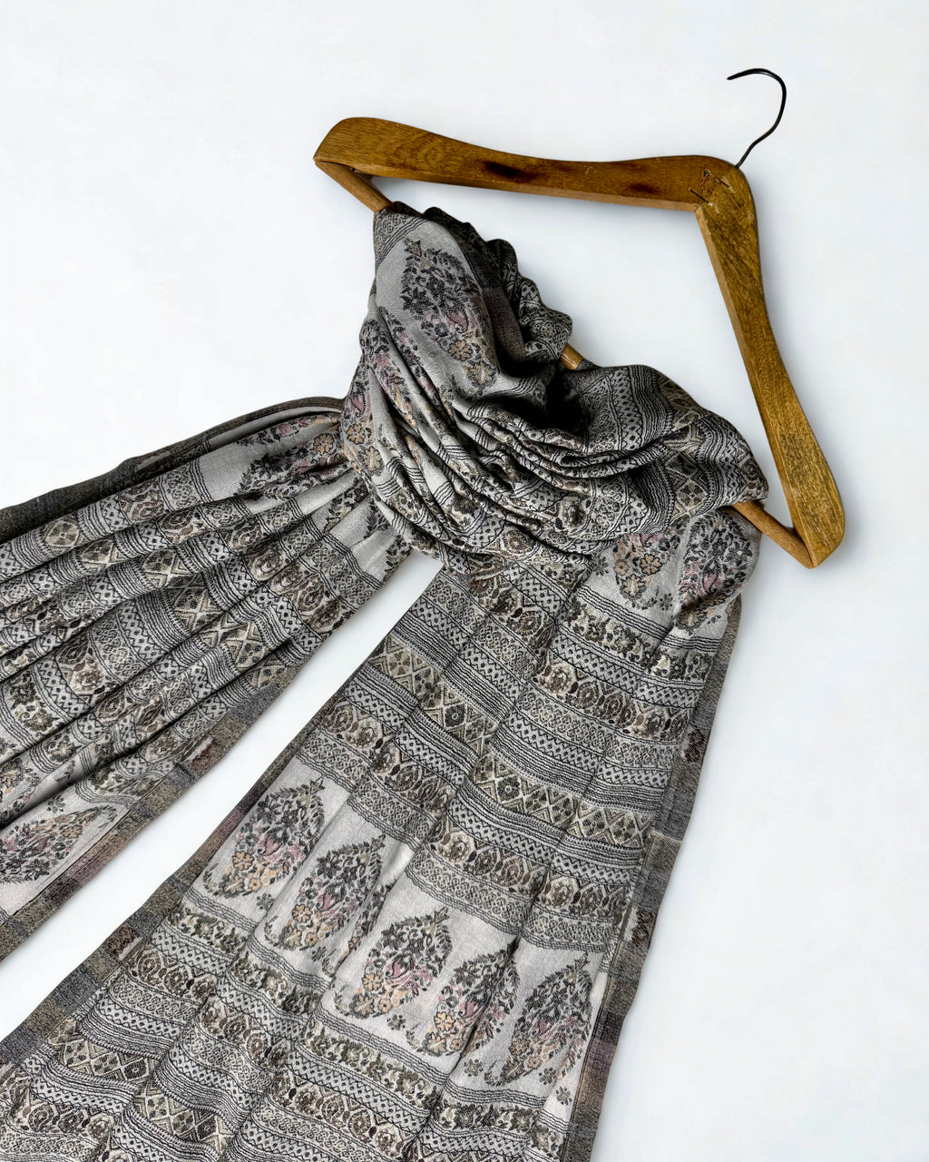 Close view of the banded paisley and geometric weave on a silver grey Indian pashmina shawl