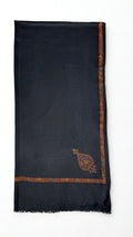 Charcoal grey Swati Shahtoosh shawl in soft folds, hand-embroidered border in rust and rose with a large paisley corner buta