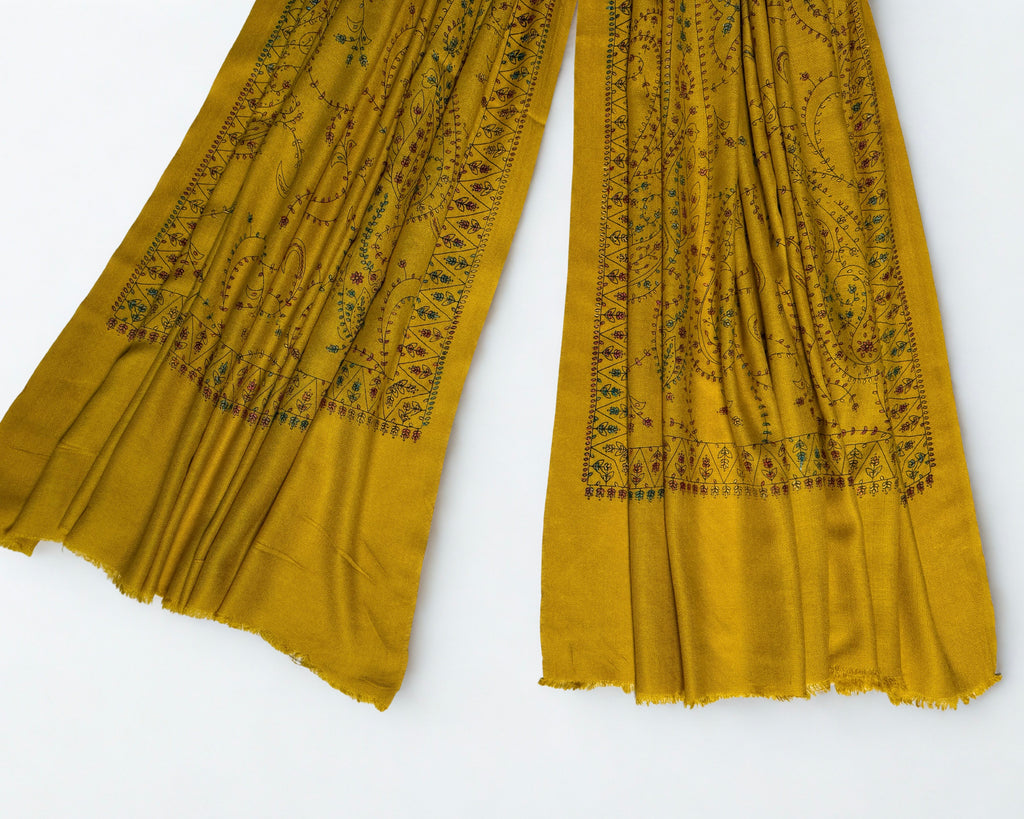 Ends of the mustard Swati Shahtoosh shawl showing the triangular flower border and fringed edge