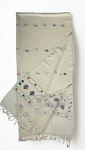 Off-white Khadi Swati Shahtoosh shawl folded lengthwise, showing the woven multicoloured buti and the diamond medallion border at the fringed end
