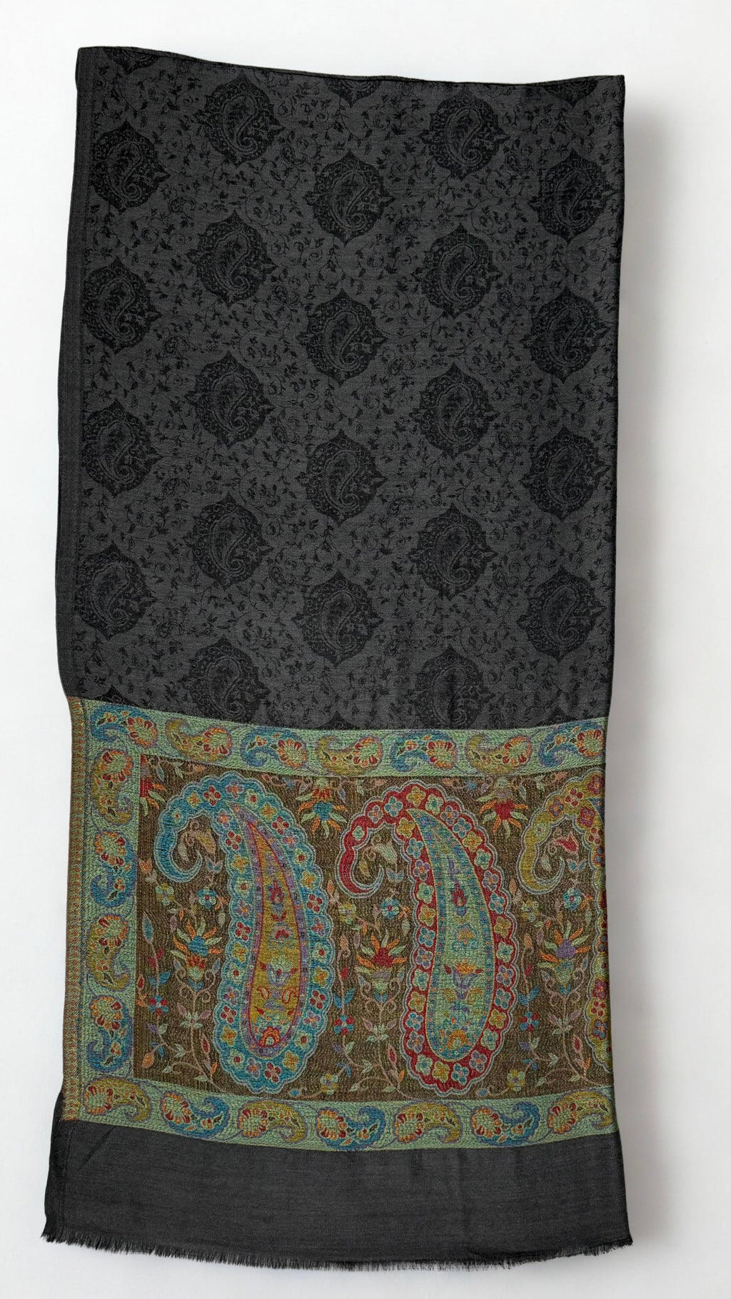 Dark charcoal pashmina ring shawl folded, showing the black paisley medallion lattice and a palla of large teal, crimson and saffron paisleys