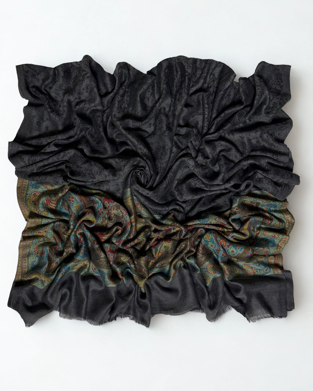 Dark charcoal fine pashmina ring shawl swirled from above, the dark field over the multicolour paisley palla