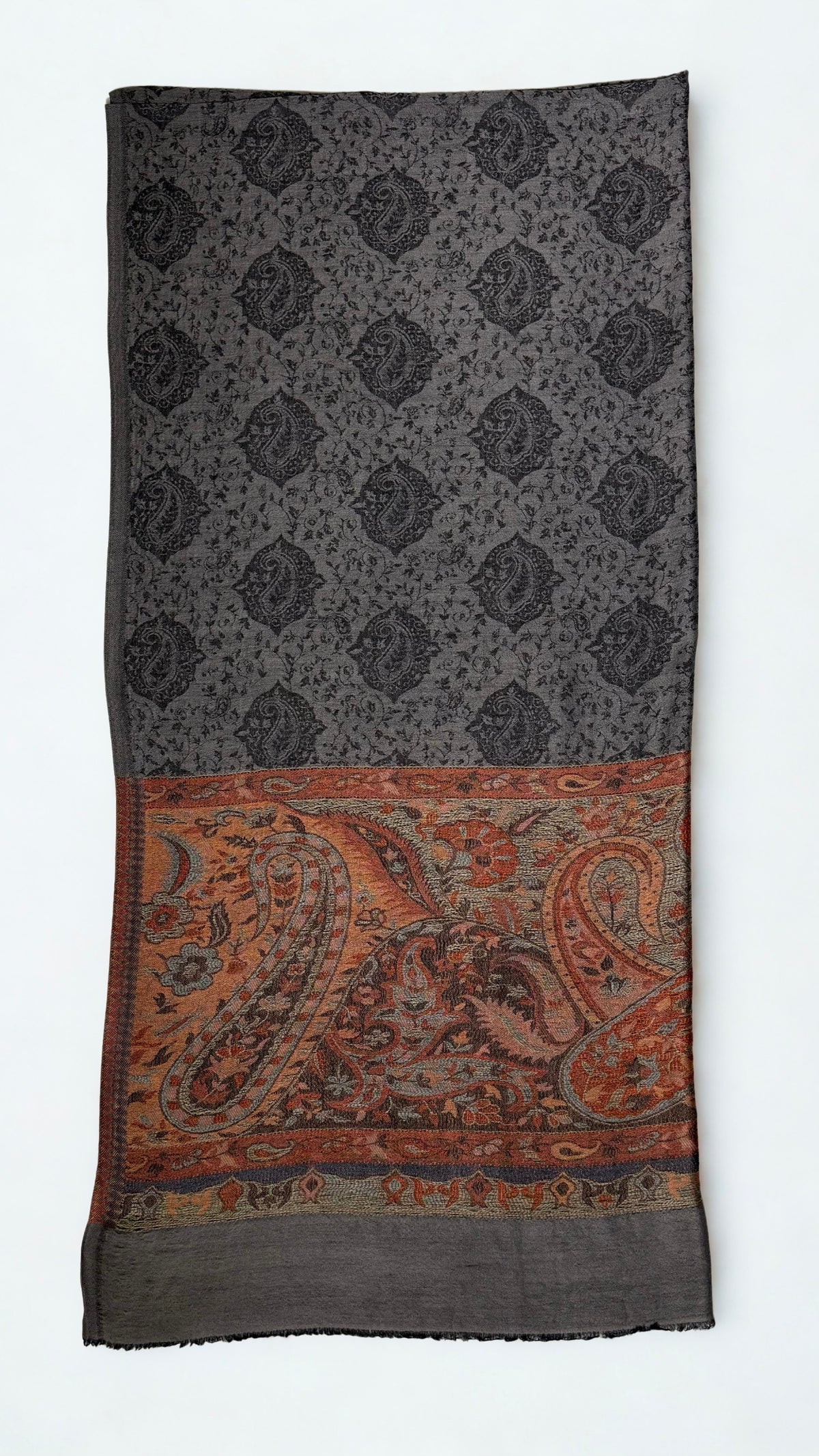Charcoal pashmina ring shawl folded flat, showing the black paisley medallion lattice and the deep rust, copper and sage paisley pallu