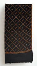 Black Swati Shahtoosh shawl folded full length, hand-embroidered gold jaal across the whole field