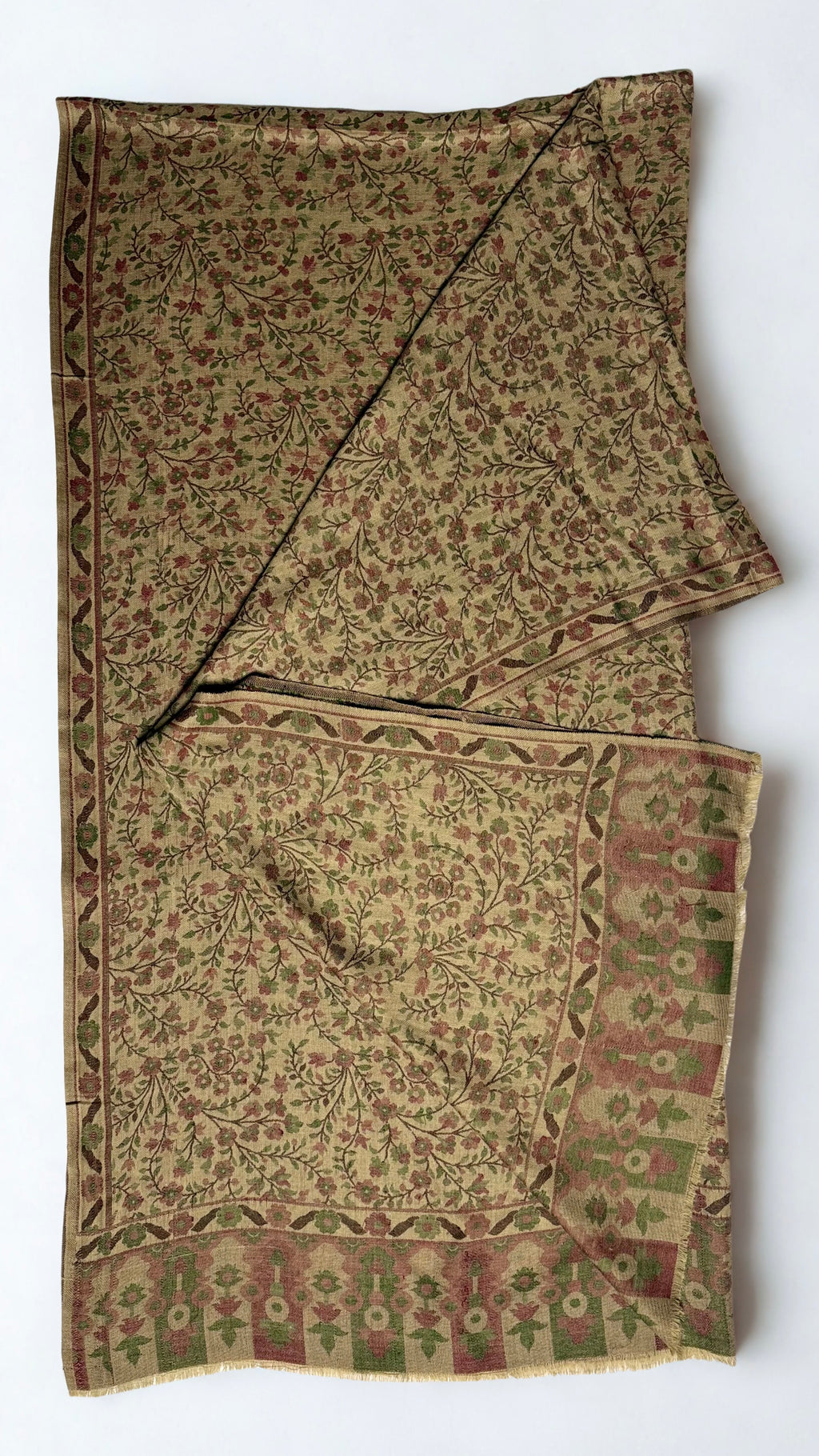 Antique gold Kani pashmina shawl knotted and draped, showing the rose and olive flowering vine weave and running side border