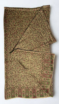Antique gold Kani pashmina shawl knotted and draped, showing the rose and olive flowering vine weave and running side border