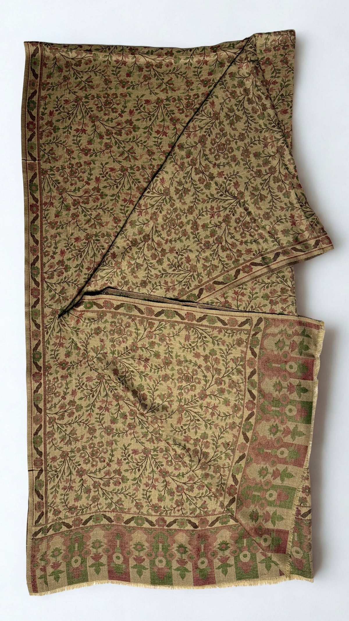 Antique gold Kani pashmina shawl knotted and draped, showing the rose and olive flowering vine weave and running side border