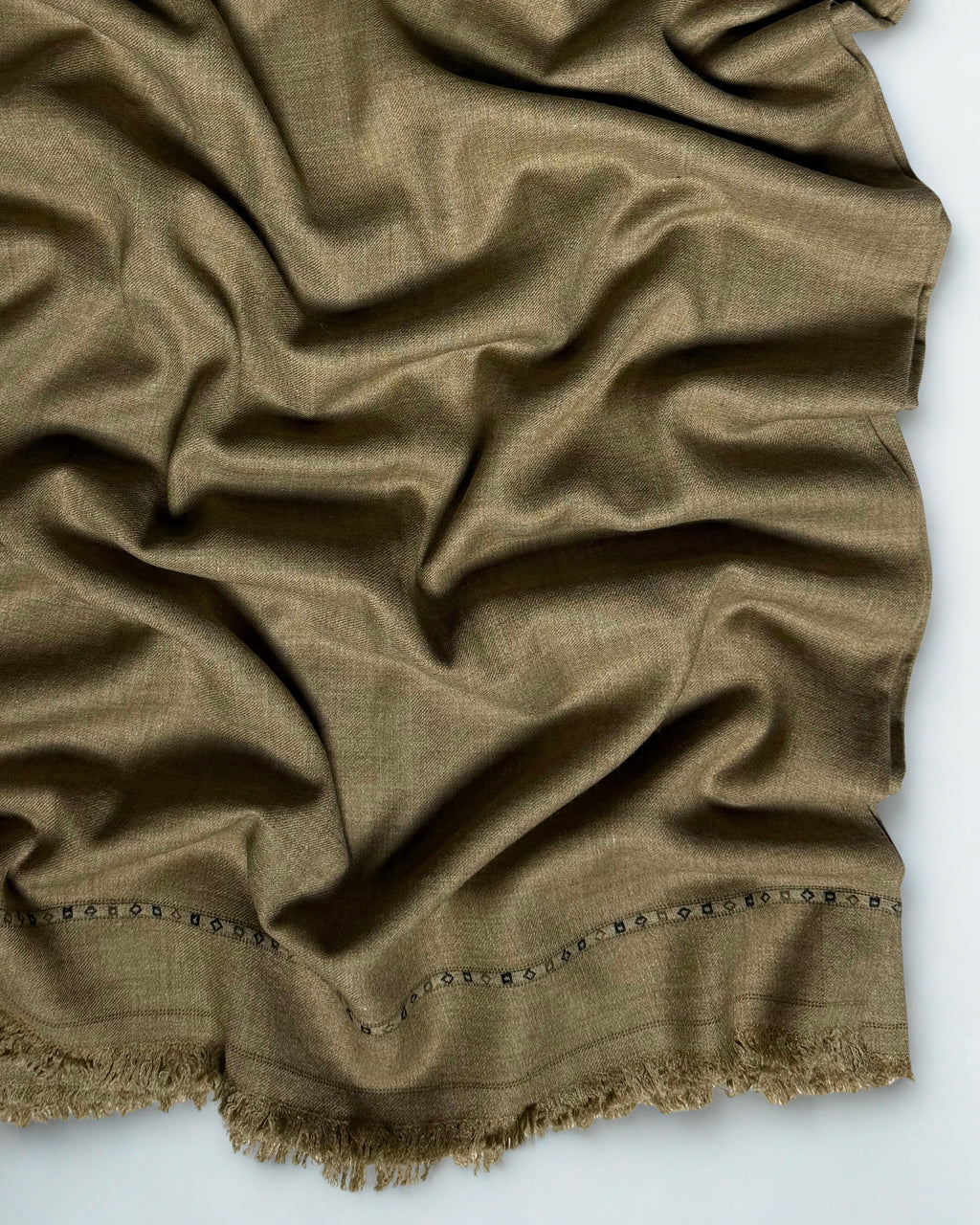 Close-up of the brown men's Swati pashmina shawl showing the fine weave and end band