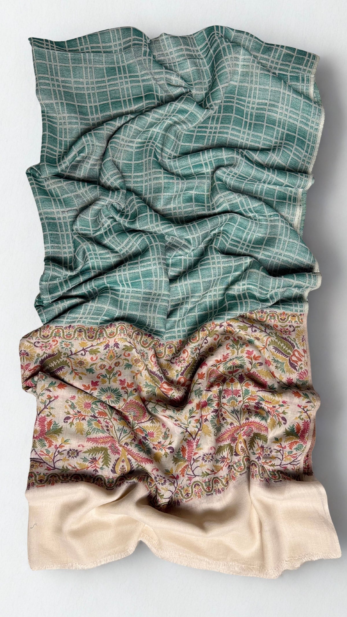 Sea green Kani pashmina shawl gathered in soft folds, check field falling into the ivory floral border