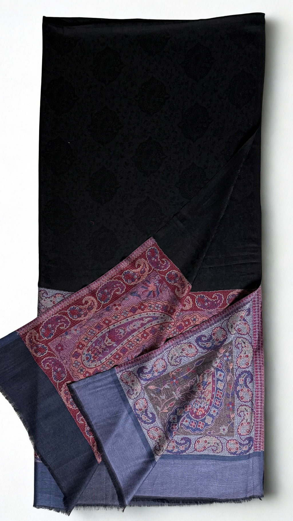 Close view of the curving paisleys in slate blue, plum, rose and pale grey