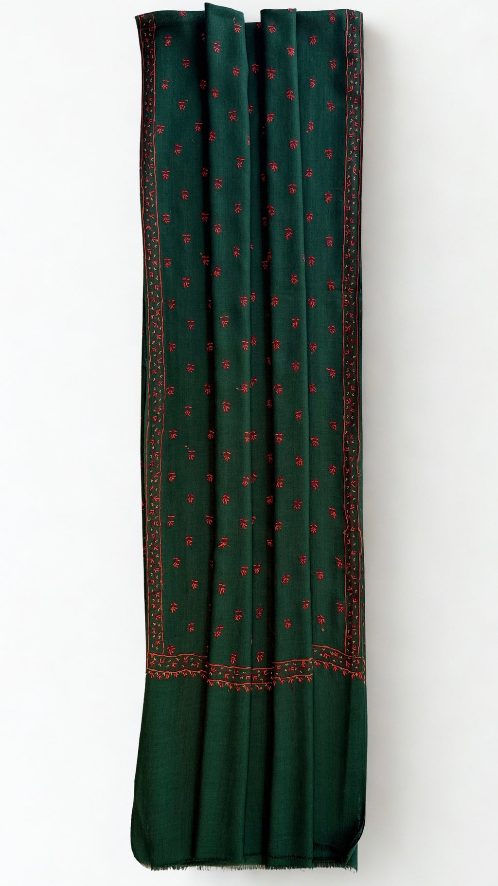 Close view of the crimson hand-embroidered border and buti on emerald Kashmiri pashmina